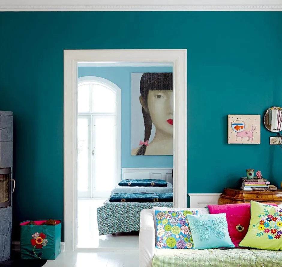 Vibrant living room with deep teal interior wall paint creating a bold residential space
